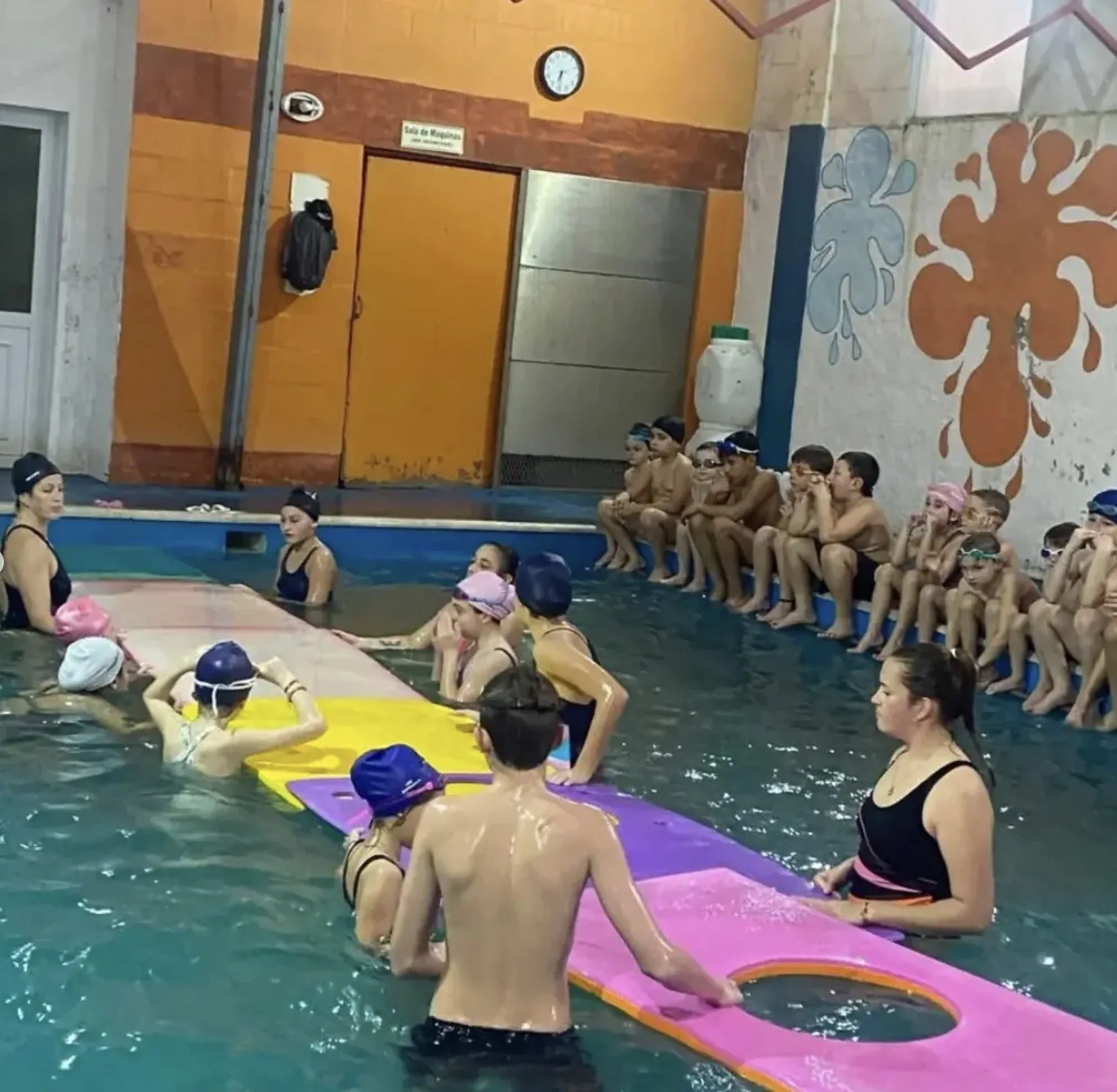 Clase con una colchoneta larga en el agua